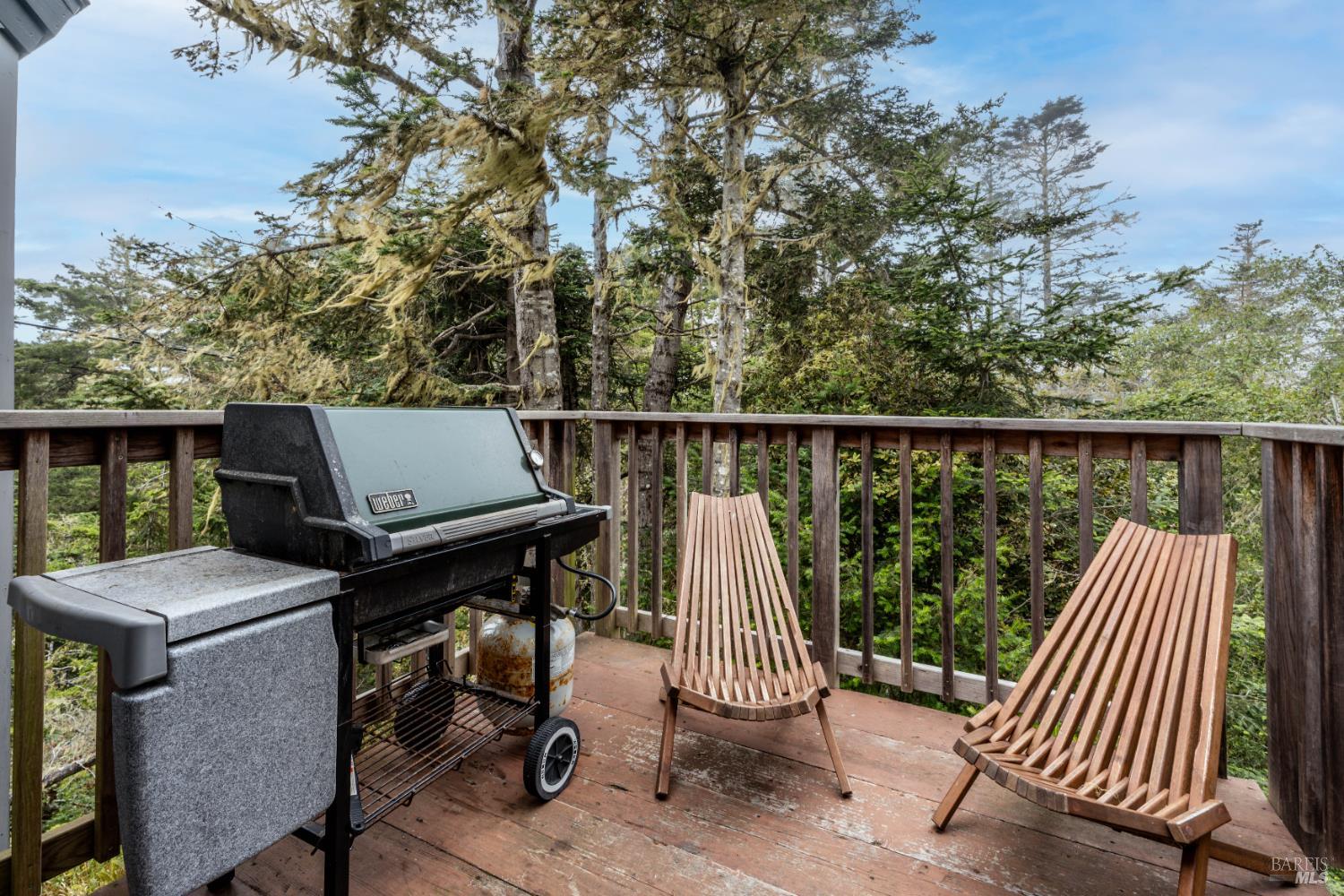 15741 Forest View Road Manchester, CA 95459 - Photo 21 of 28 a view of roof deck with chairs and wooden fence