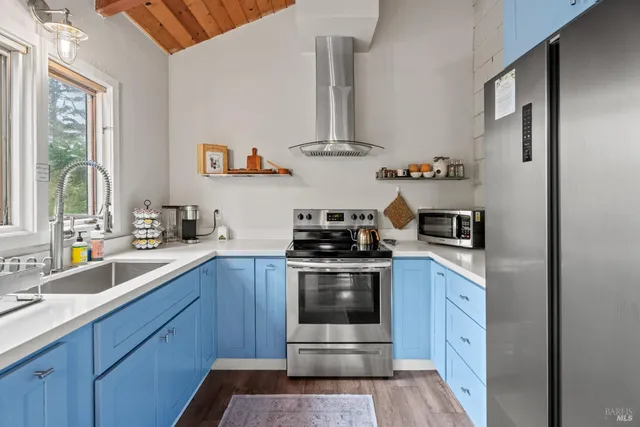 a kitchen with stainless steel appliances granite countertop a sink and wooden cabinets