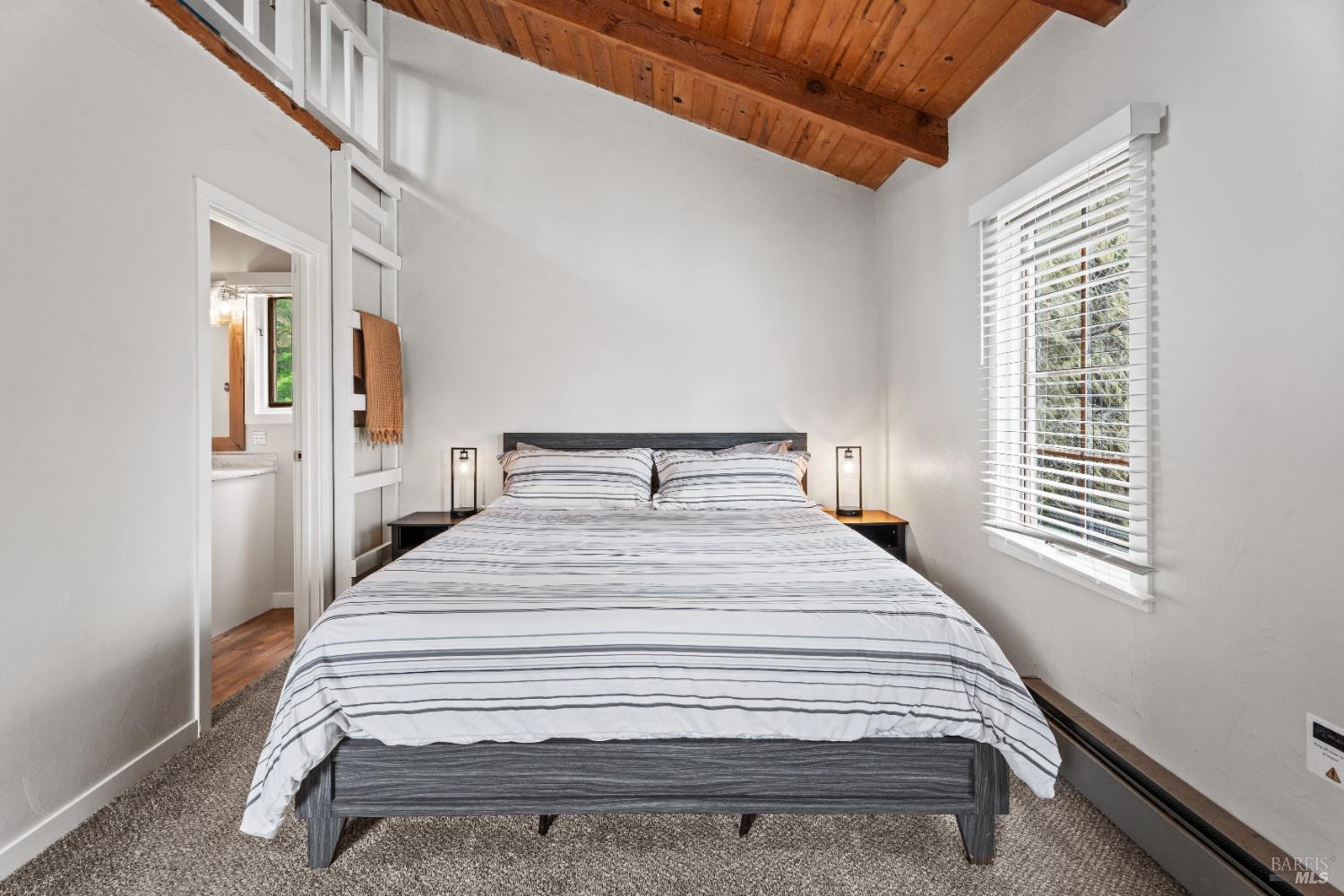 15741 Forest View Road Manchester, CA 95459 - Photo 10 of 28 a bedroom with a bed and wooden floor