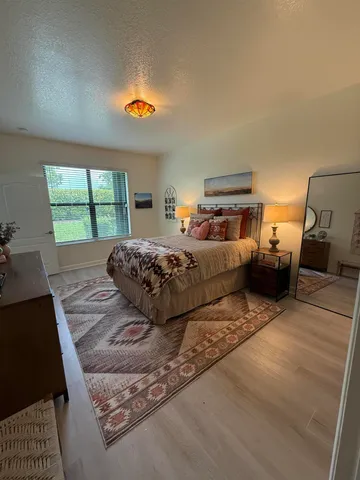 a bedroom with a bed and a couch