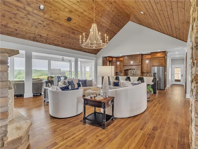 a spacious bedroom with a bed a couch and dresser