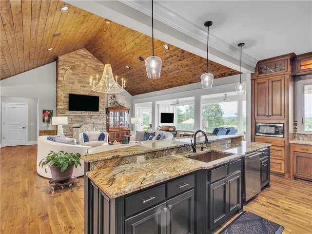 a bathroom with a granite countertop double vanity sink and a mirror