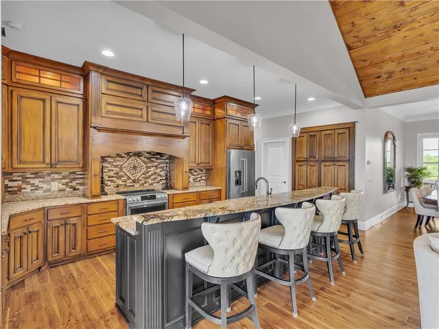 a spacious bedroom with a bed and a flat screen tv