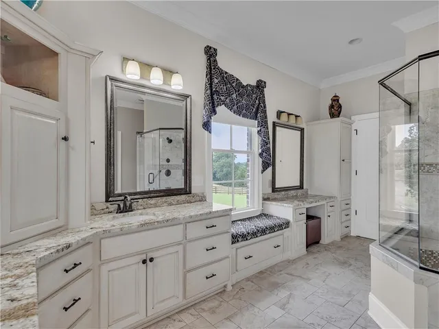 a front view of a house with a yard and potted plants