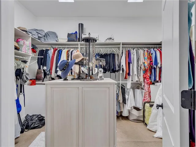 a view of a patio with couches and table and chairs with wooden floor and fence