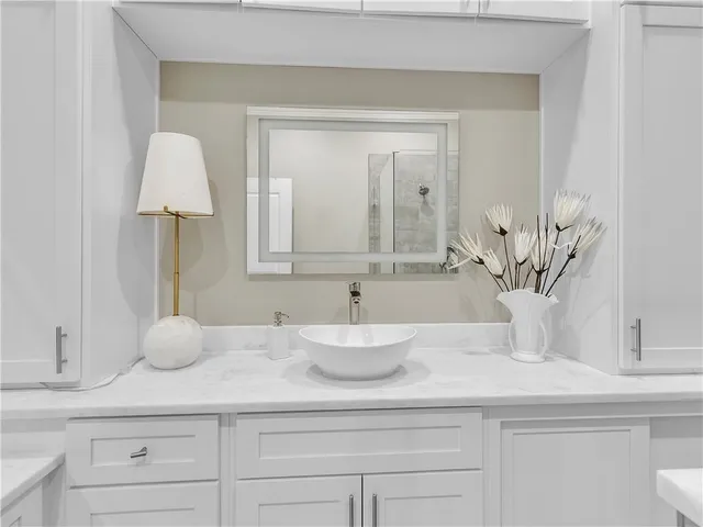 a view of a patio with a table and chairs under an umbrella with potted plants
