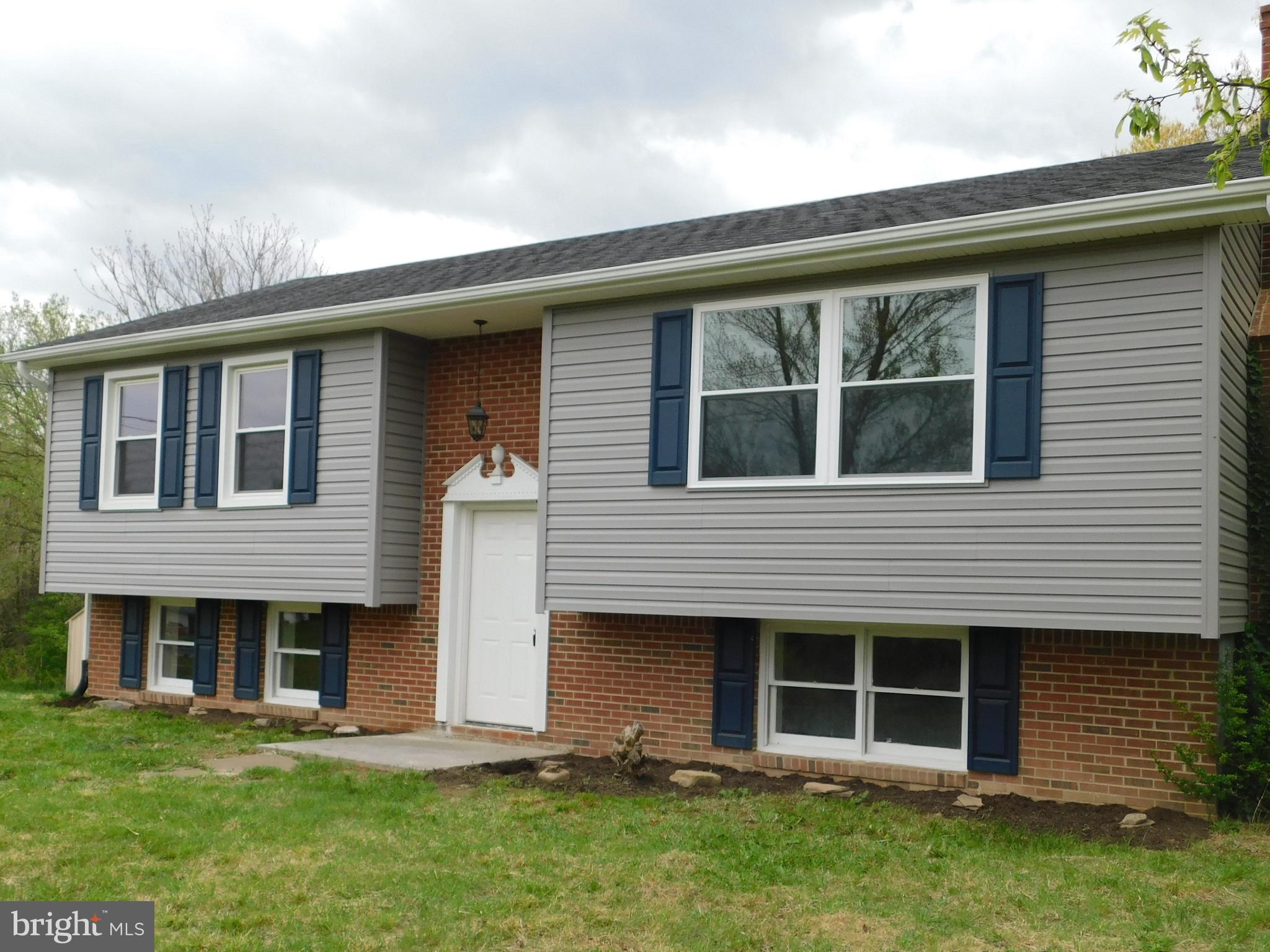 205 Guard Road Middletown, VA 22645 - Photo 2 of 26 a front view of a house with a yard