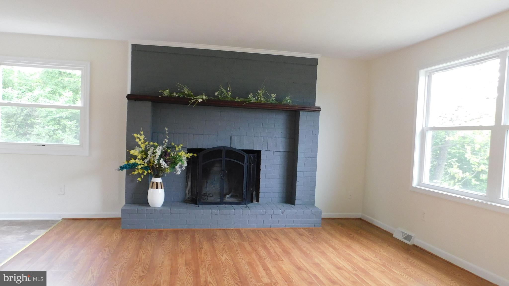 205 Guard Road Middletown, VA 22645 - Photo 13 of 26 a view of a hallway with wooden floor and a potted plant