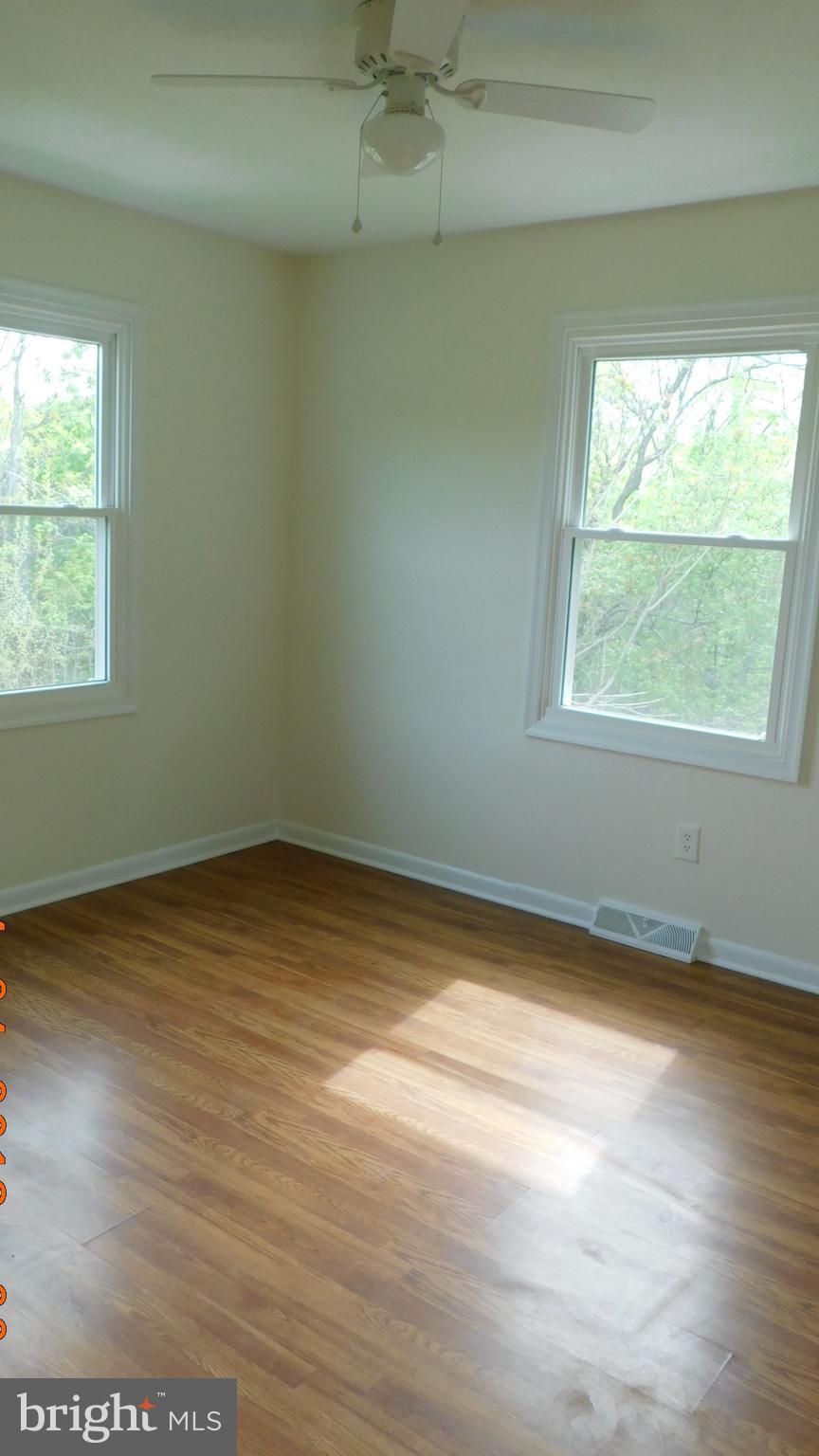 205 Guard Road Middletown, VA 22645 - Photo 14 of 26 an empty room with wooden floor and windows