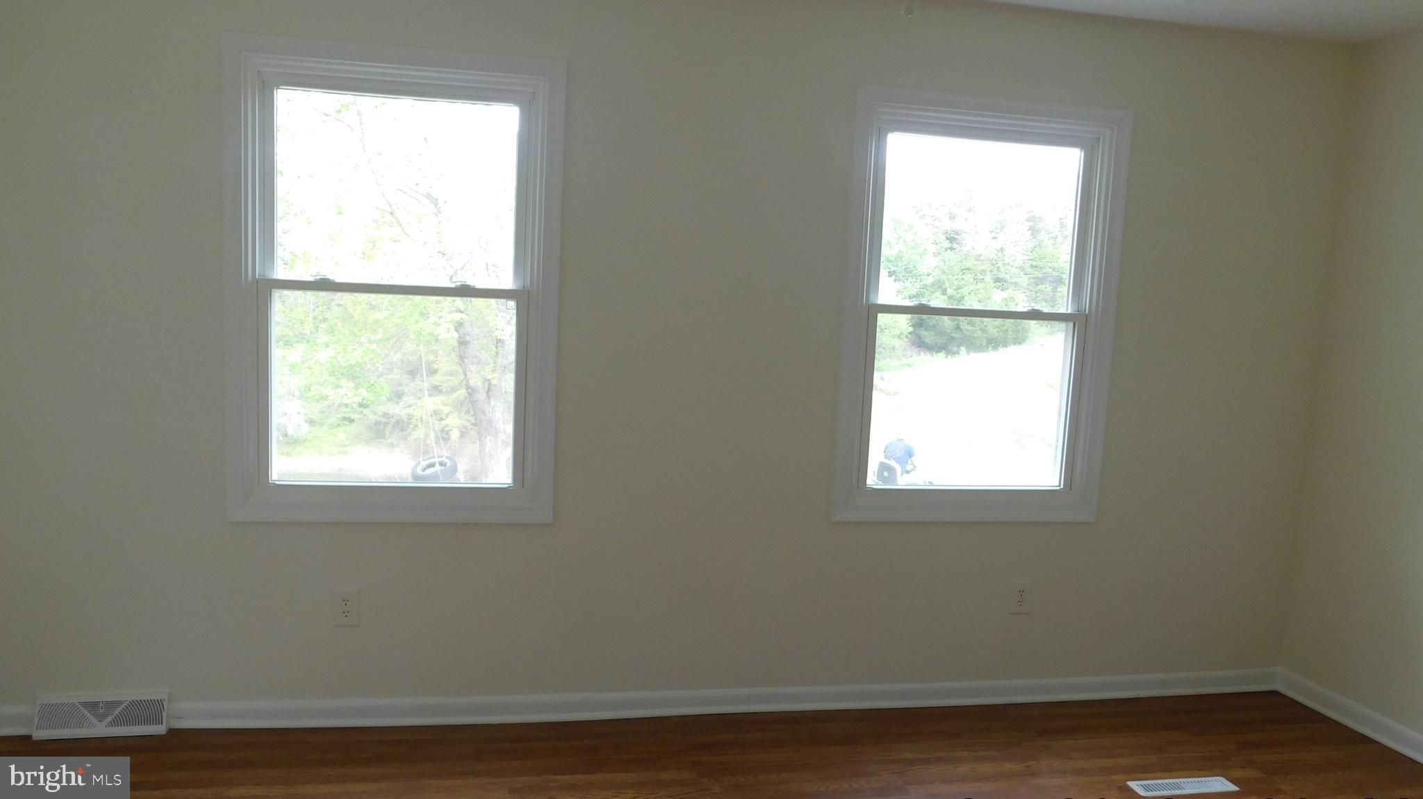205 Guard Road Middletown, VA 22645 - Photo 15 of 26 a view of an empty room with wooden floor and a window