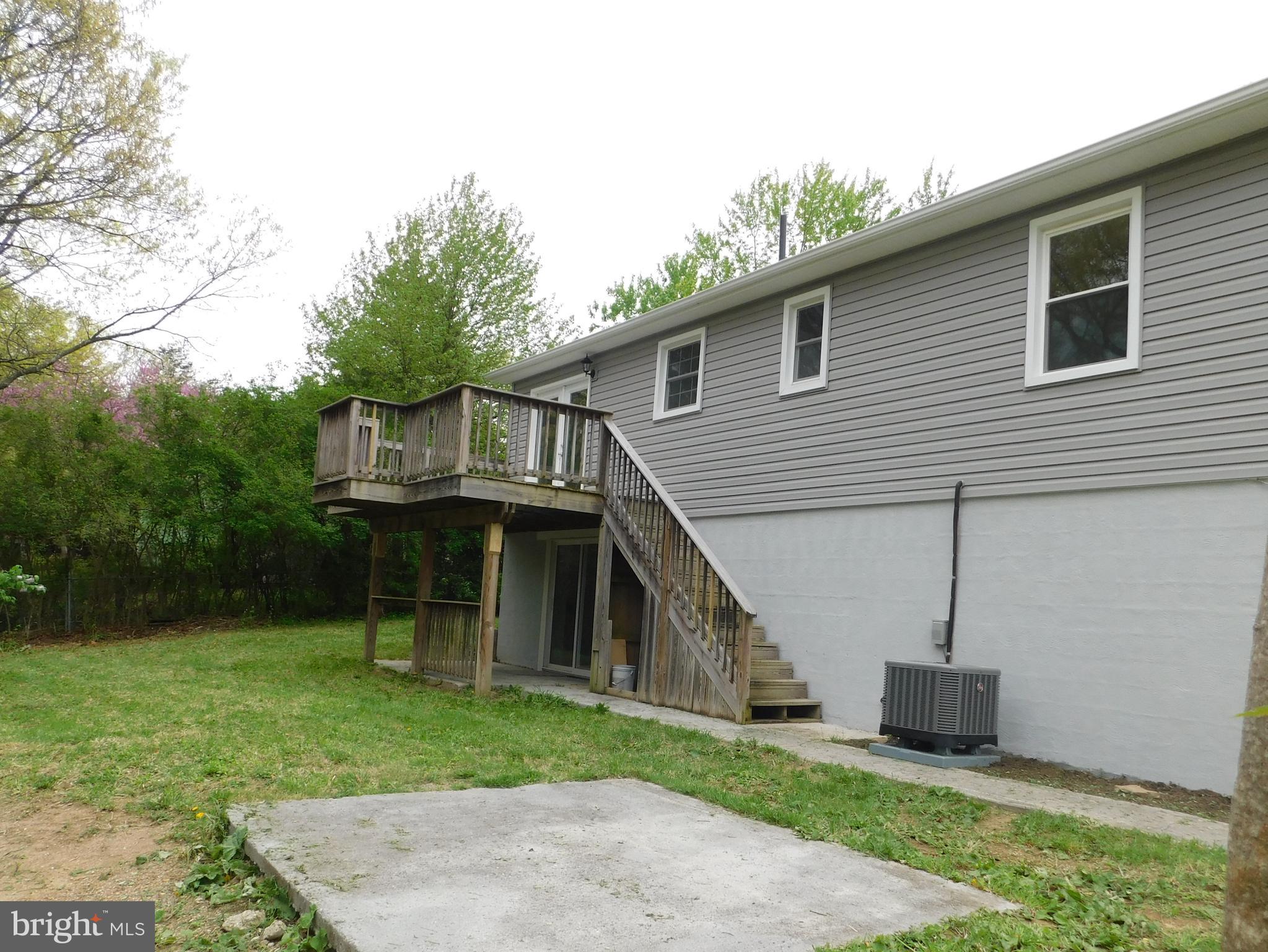 205 Guard Road Middletown, VA 22645 - Photo 25 of 26 a view of a house with a yard and deck