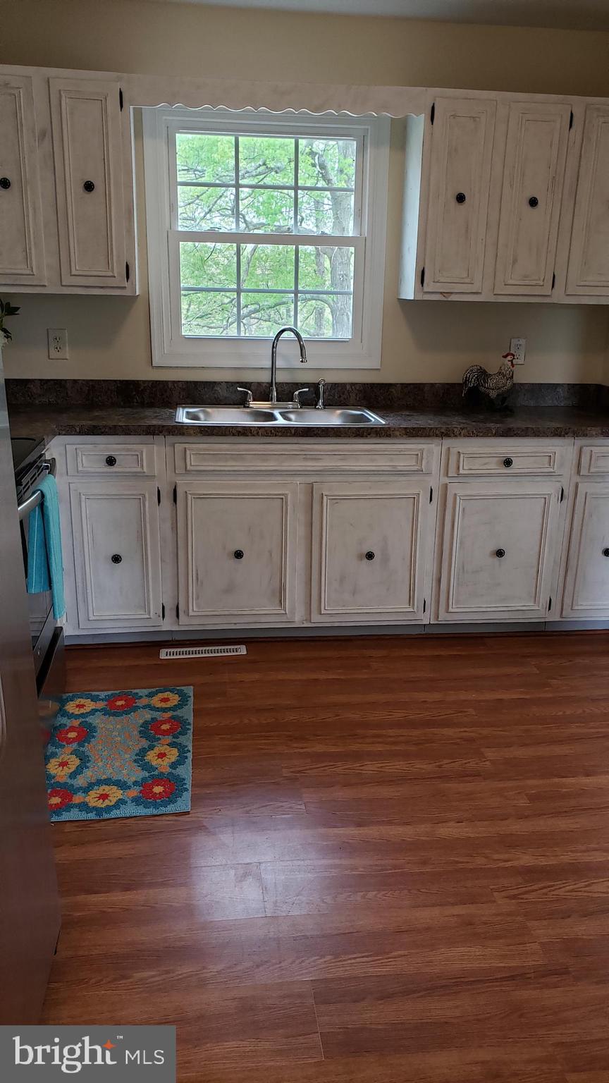 205 Guard Road Middletown, VA 22645 - Photo 7 of 26 a kitchen with stainless steel appliances wooden cabinets and a stove