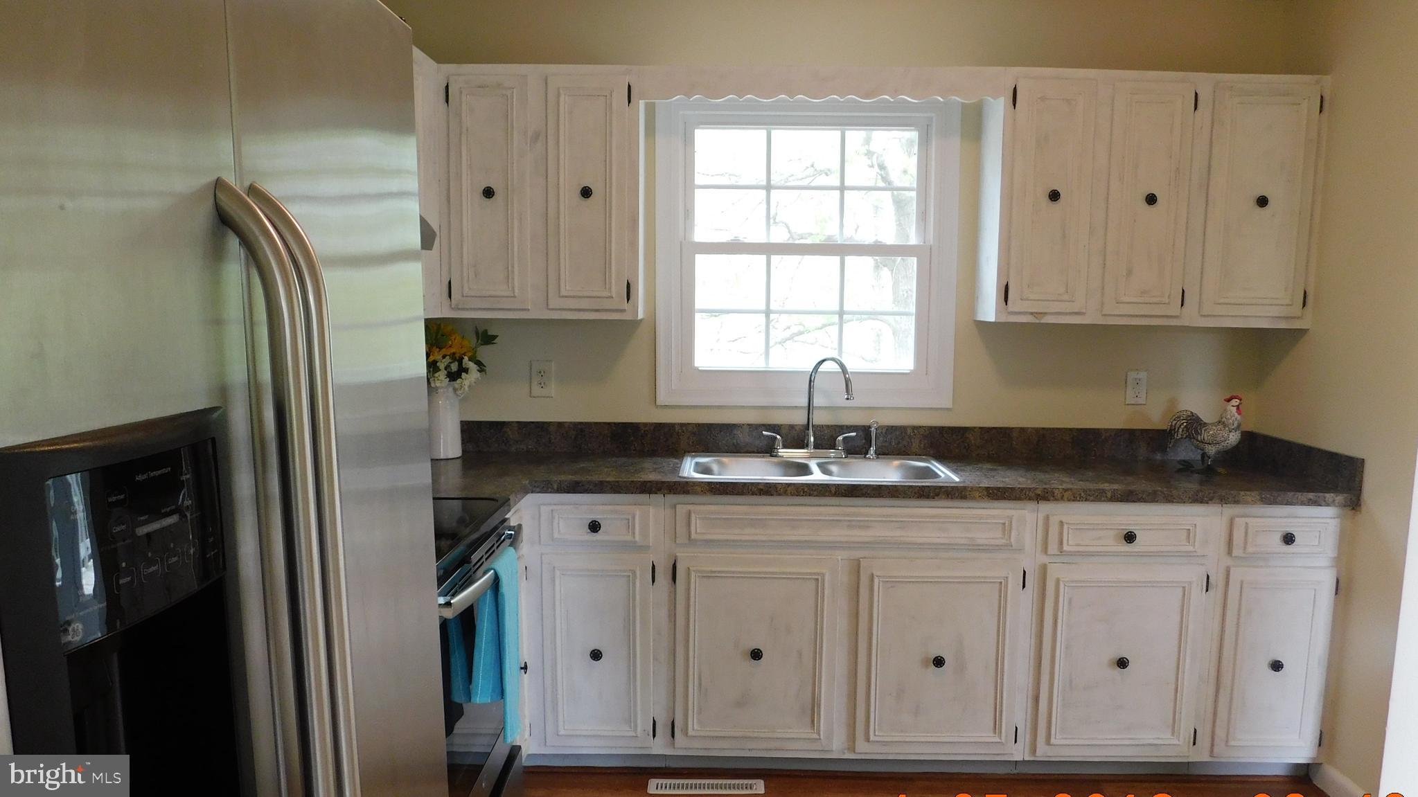 205 Guard Road Middletown, VA 22645 - Photo 8 of 26 a kitchen with granite countertop a sink stainless steel appliances and cabinets
