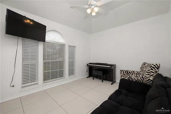 a bedroom with a bed and a television