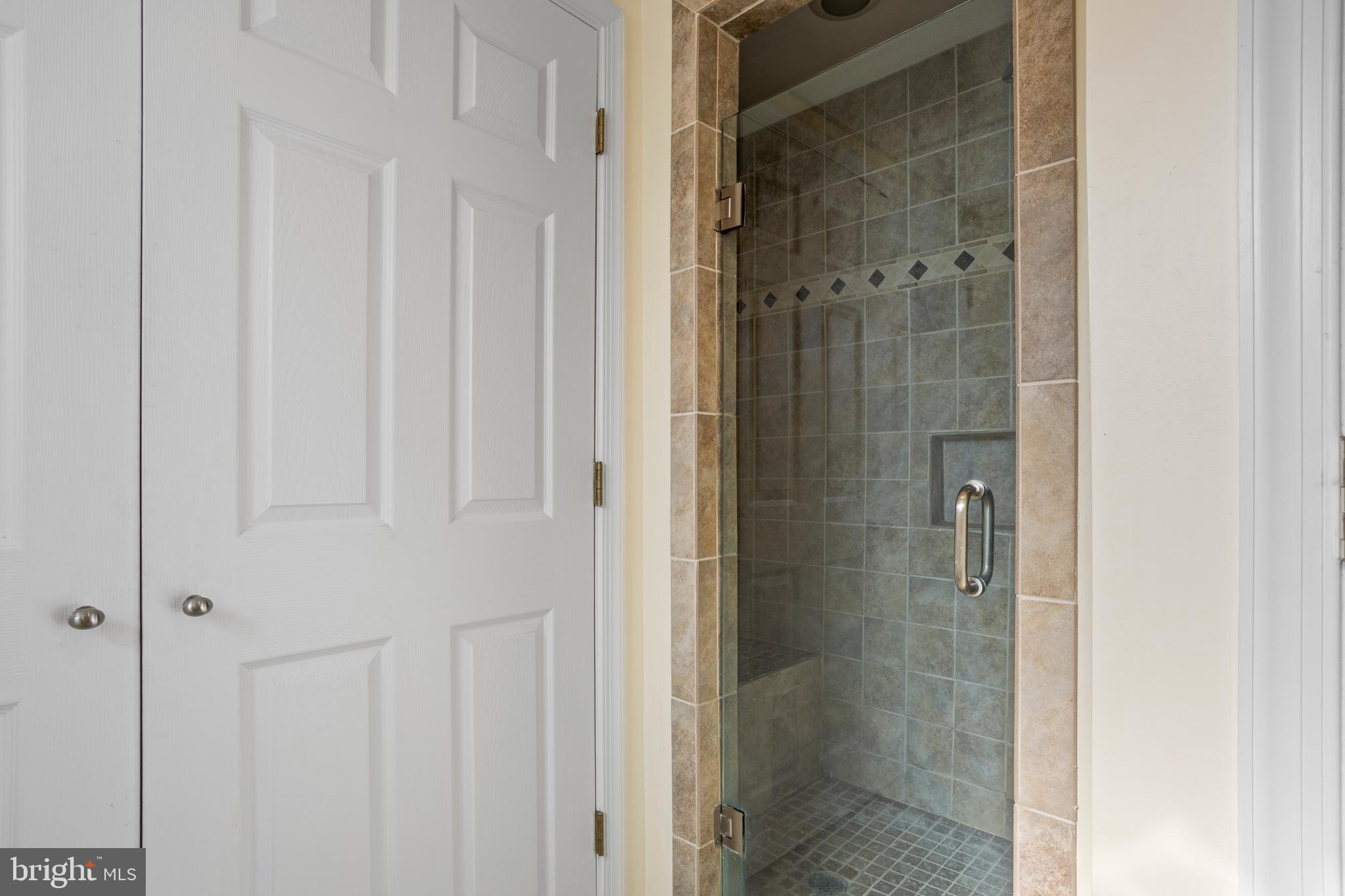 7410 Dakota Avenue Chesapeake Beach, MD 20732 - Photo 39 of 68 a bathroom with a glass shower door