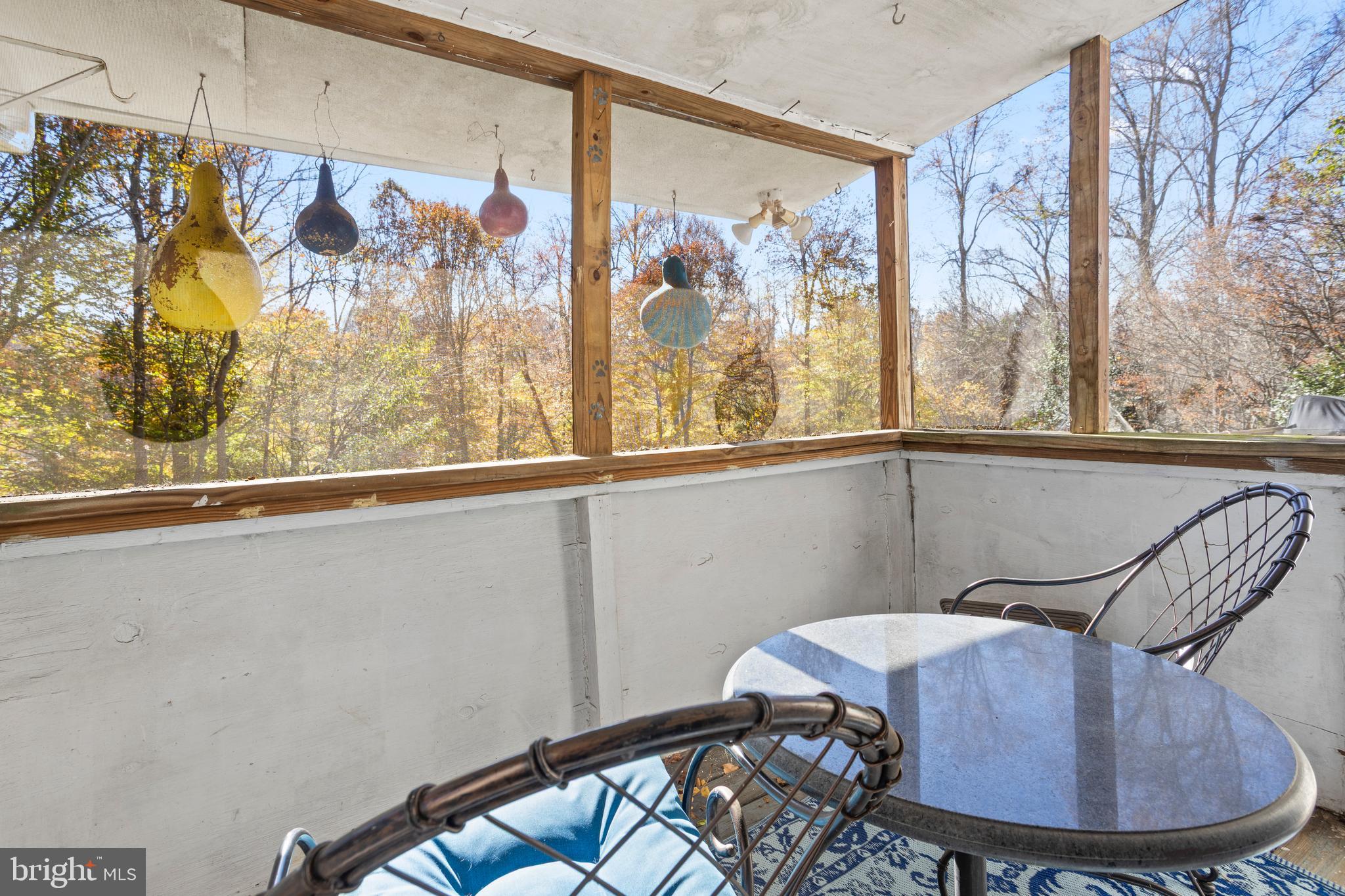 7410 Dakota Avenue Chesapeake Beach, MD 20732 - Photo 43 of 68 a view of a dining room with furniture a chandelier and wooden floor