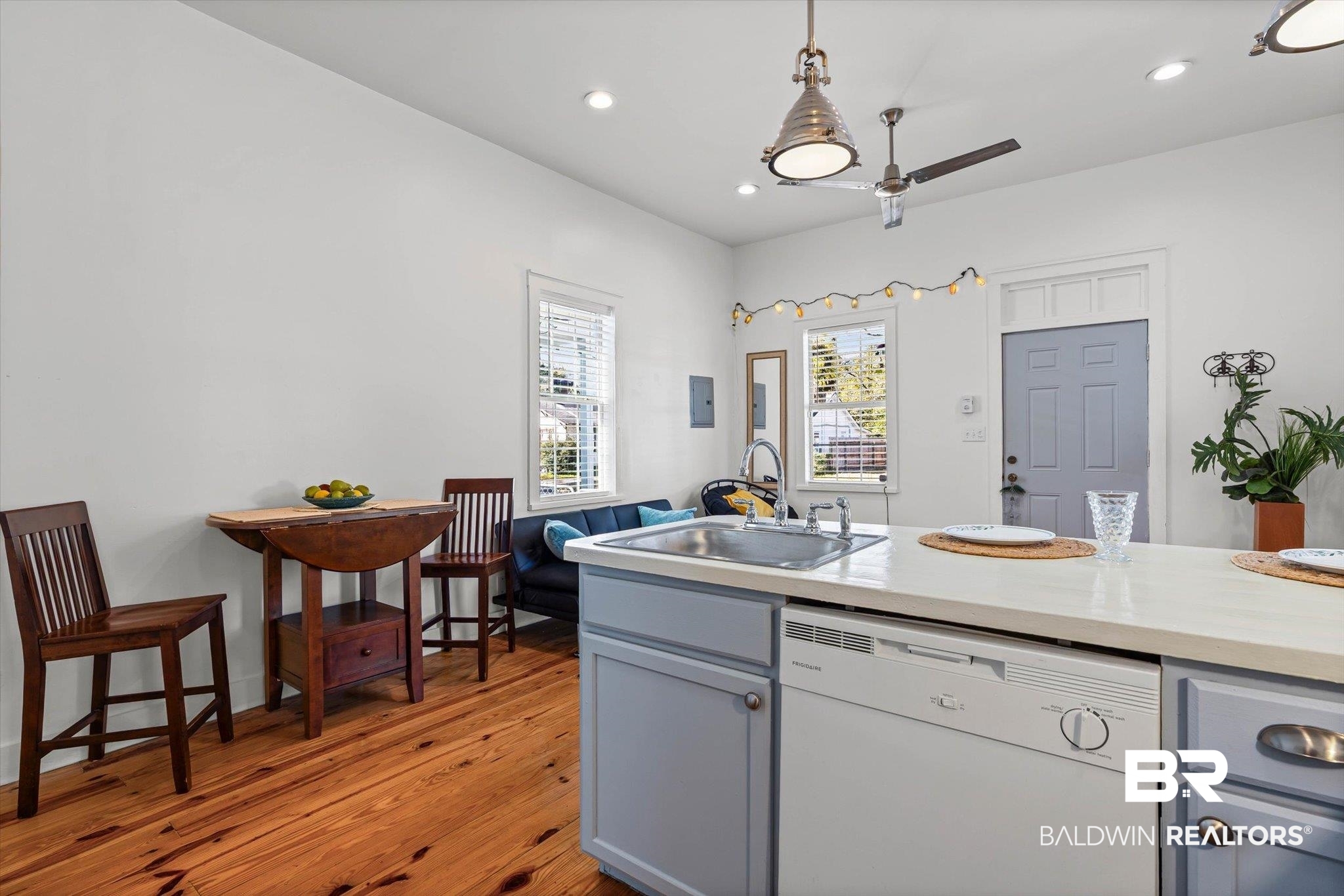951 Montgomery Street Mobile, AL 36604 - Photo 8 of 22 Kitchen featuring a white dishwasher, stainless steel sink, light-colored countertops, and light blue cabinetry