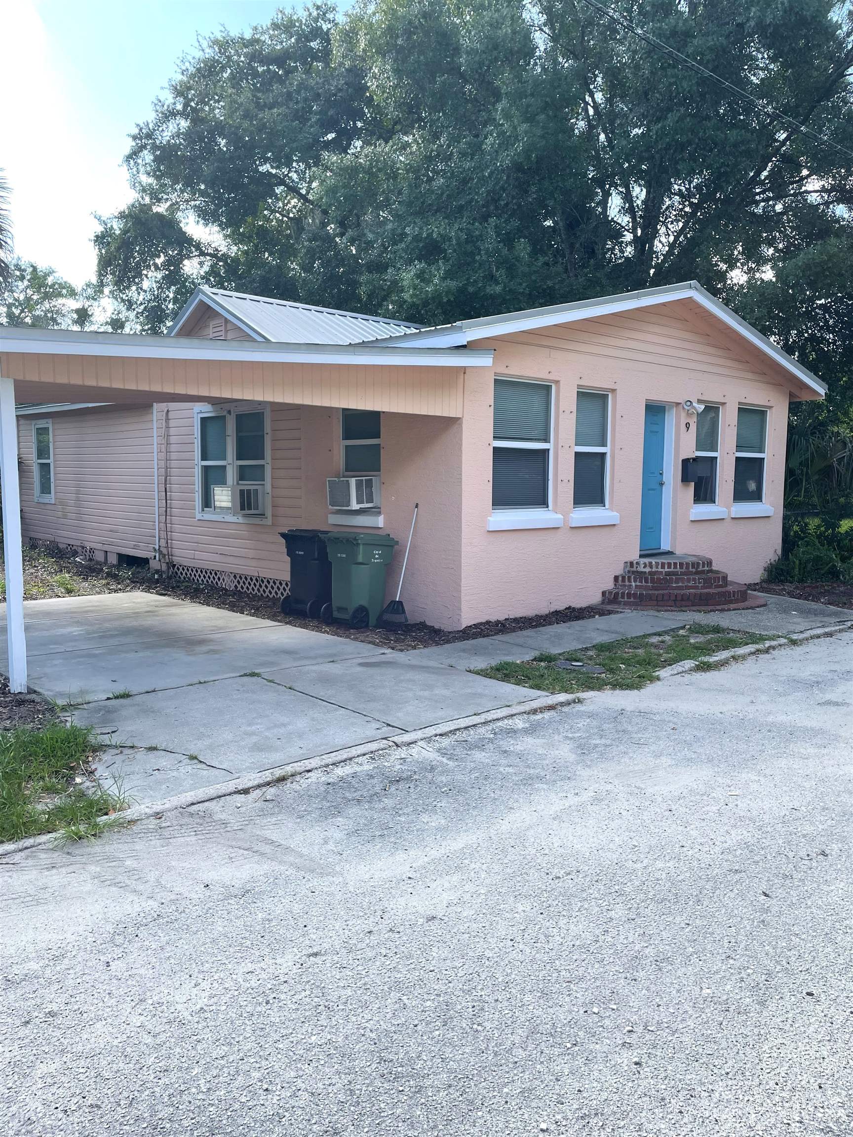 a front view of house with yard and trees in the background