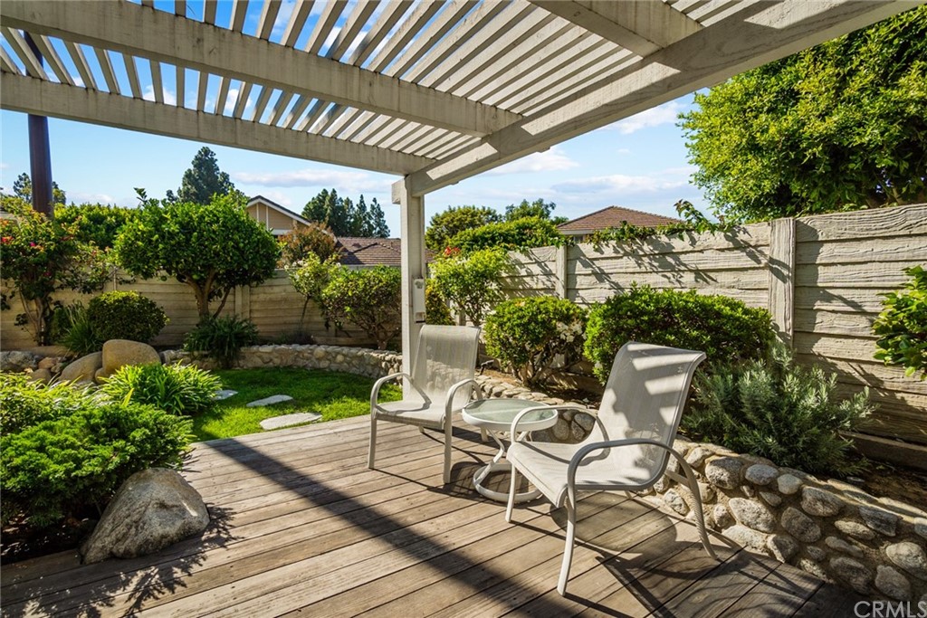 5 Elderwood, Unit 19 Irvine, CA 92614 - Photo 1 of 39 a view of a patio with table and chairs potted plants and floor to ceiling window and wooden fence