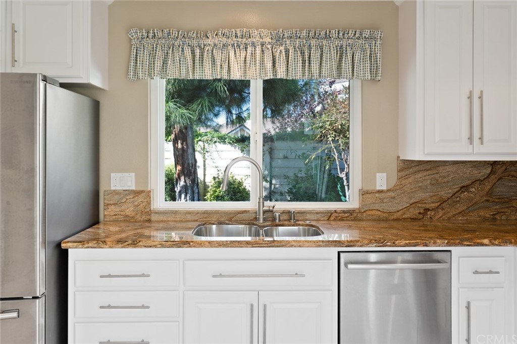 5 Elderwood, Unit 19 Irvine, CA 92614 - Photo 13 of 39 a bathroom with a granite countertop sink and a mirror