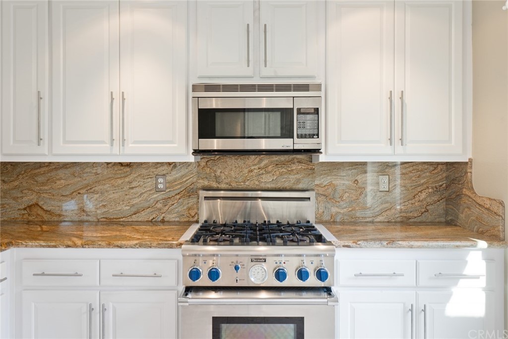 5 Elderwood, Unit 19 Irvine, CA 92614 - Photo 14 of 39 a stove top oven sitting inside of a kitchen