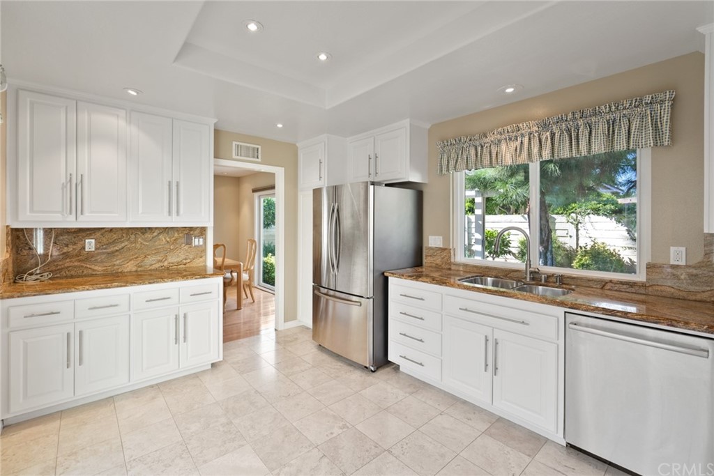 5 Elderwood, Unit 19 Irvine, CA 92614 - Photo 15 of 39 a large kitchen with stainless steel appliances granite countertop a refrigerator and a sink