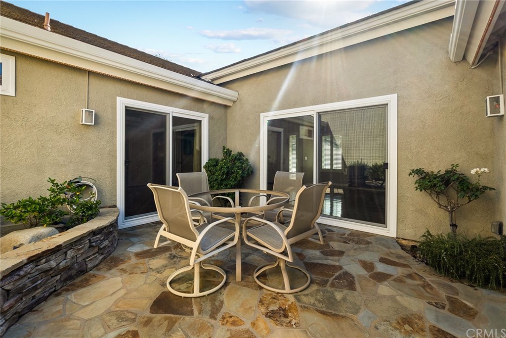 5 Elderwood, Unit 19 Irvine, CA 92614 - Photo 19 of 39 a patio with table and chairs potted plants