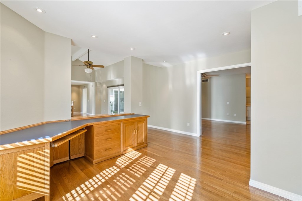 5 Elderwood, Unit 19 Irvine, CA 92614 - Photo 27 of 39 a view of a kitchen with kitchen island granite countertop wooden floor and stainless steel appliances
