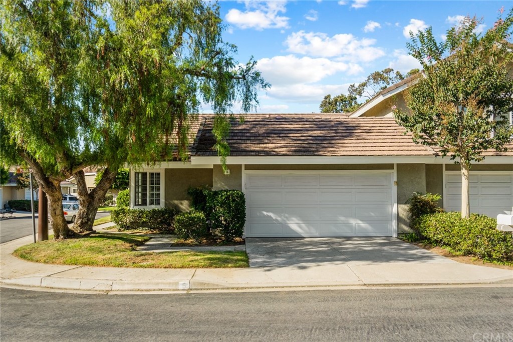5 Elderwood, Unit 19 Irvine, CA 92614 - Photo 3 of 39 a front view of a house with a yard and garage