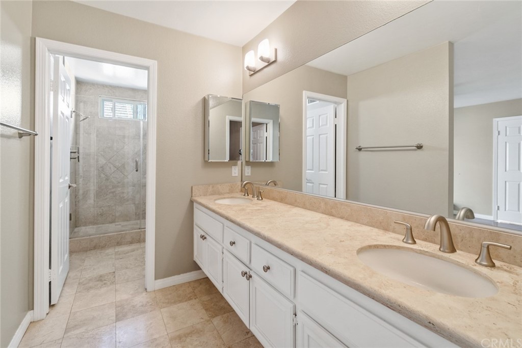 5 Elderwood, Unit 19 Irvine, CA 92614 - Photo 31 of 39 a bathroom with double sink and a mirror