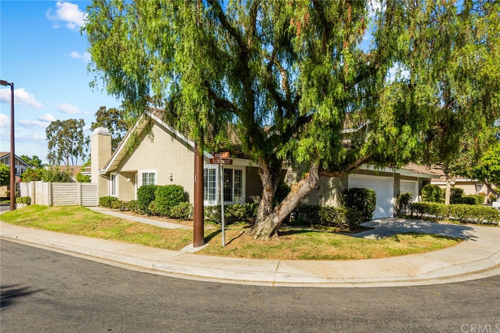 5 Elderwood, Unit 19 Irvine, CA 92614 - Photo 38 of 39 a front view of a house with a yard