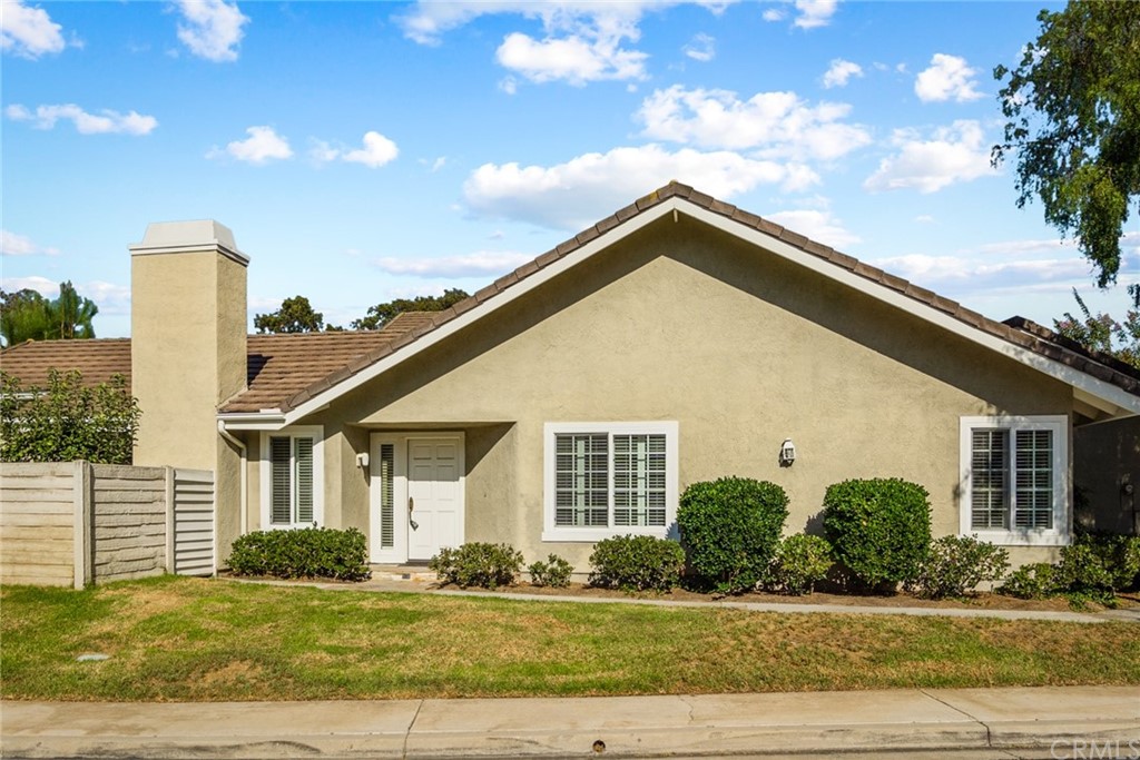5 Elderwood, Unit 19 Irvine, CA 92614 - Photo 39 of 39 a front view of a house with a yard