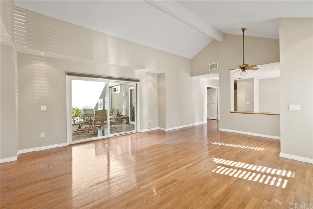 5 Elderwood, Unit 19 Irvine, CA 92614 - Photo 7 of 39 a view of an empty room with wooden floor and a window