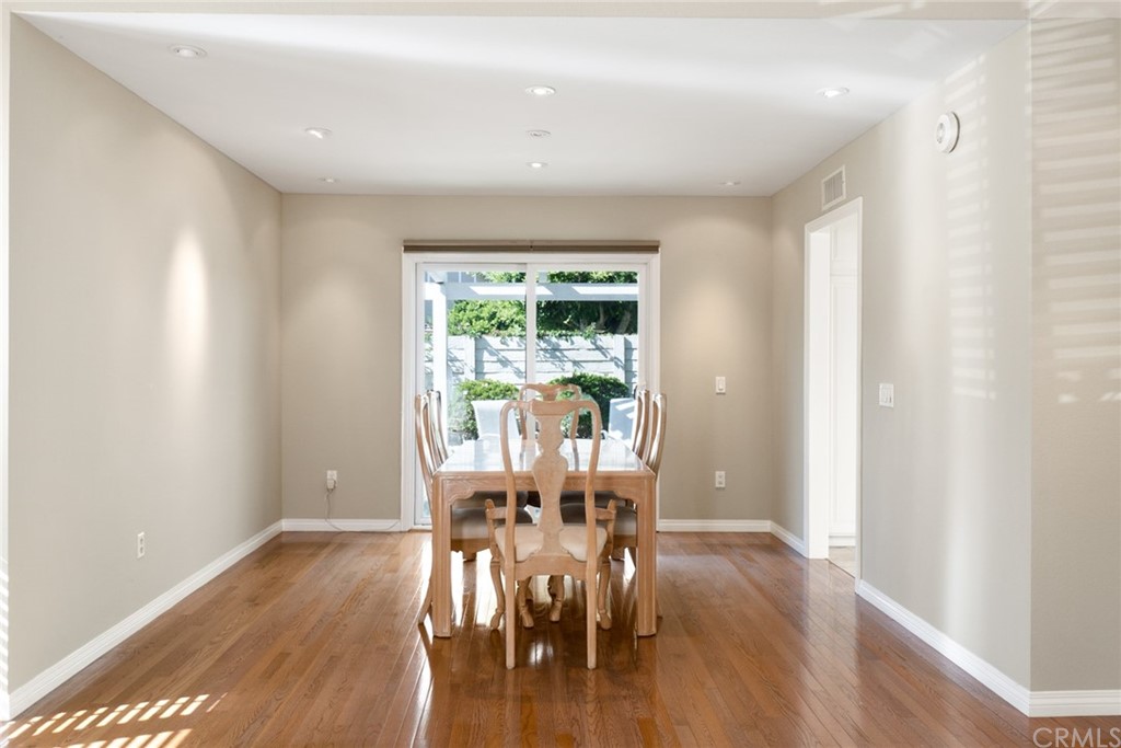5 Elderwood, Unit 19 Irvine, CA 92614 - Photo 9 of 39 a view of a dining room with furniture window and wooden floor