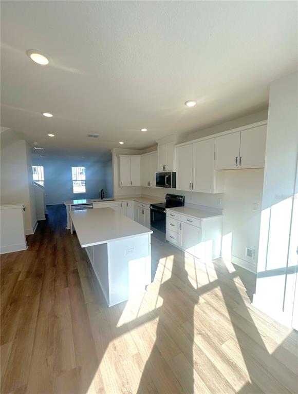 15274 Groveside Road Winter Garden, FL 34787 - Photo 4 of 4 a large white kitchen with a large window