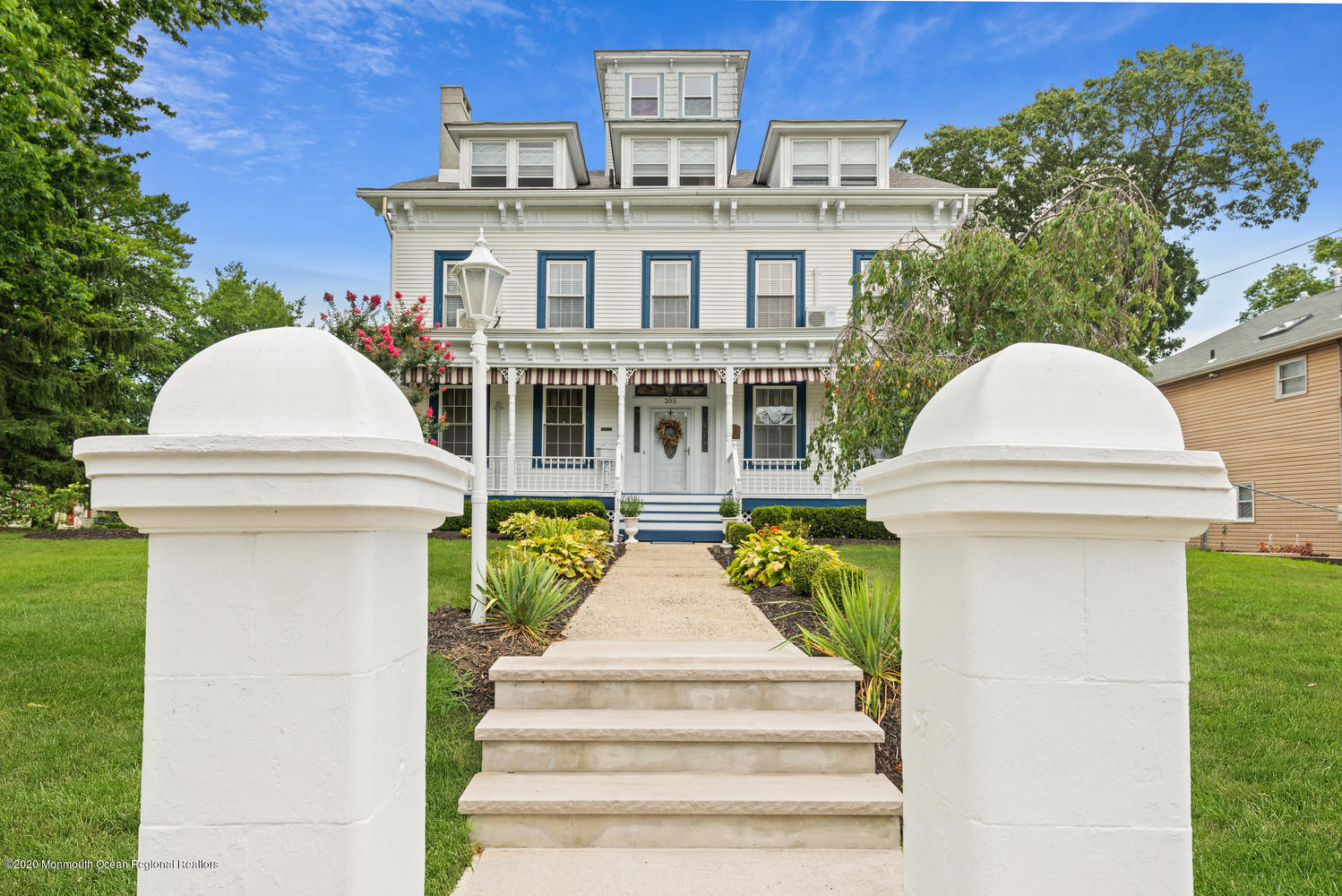 205 Main Street Keyport, NJ 07735 - Photo 2 of 42 a view of a white house with large windows and a table and chairs