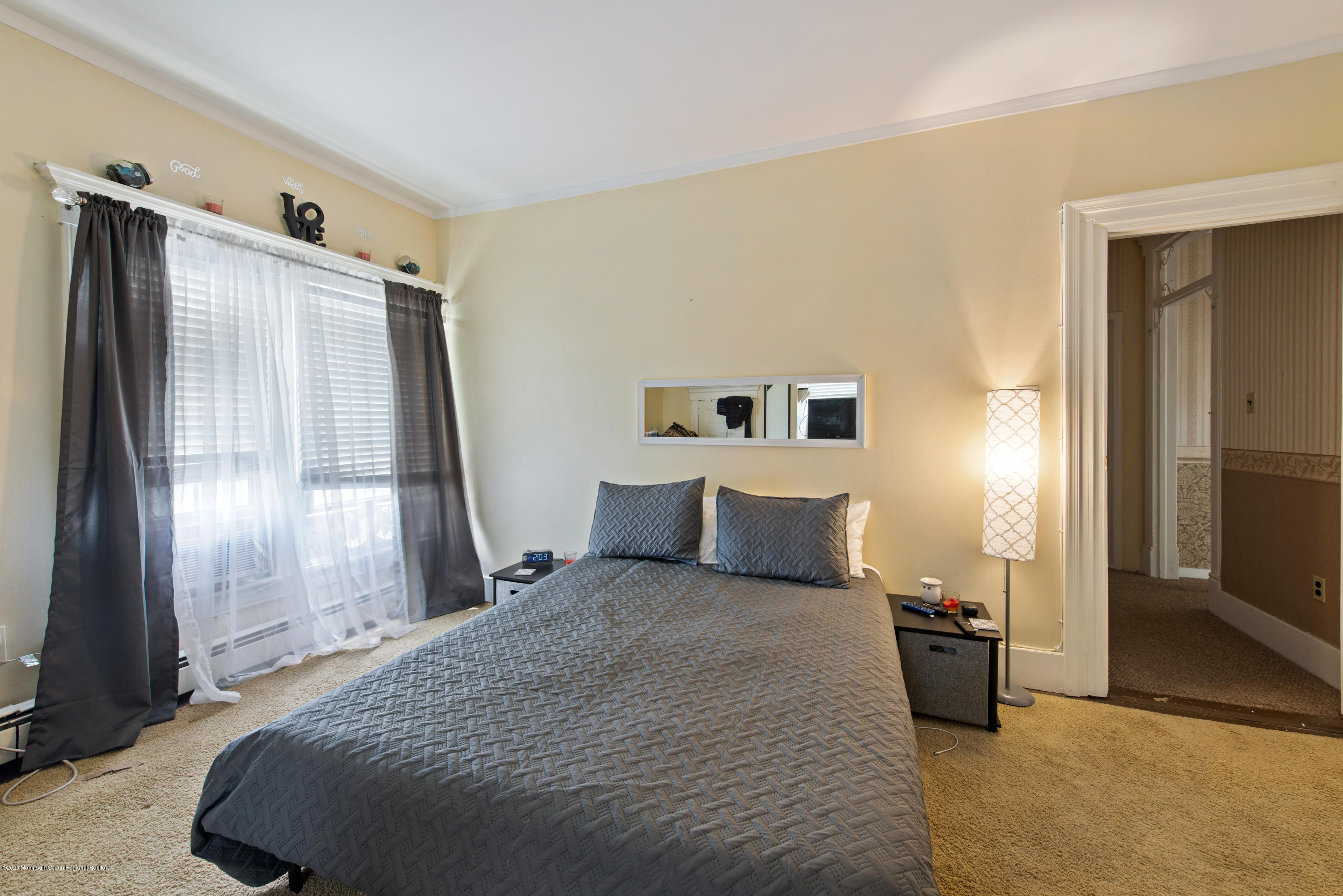 205 Main Street Keyport, NJ 07735 - Photo 33 of 42 a bedroom with a large bed and a large mirror