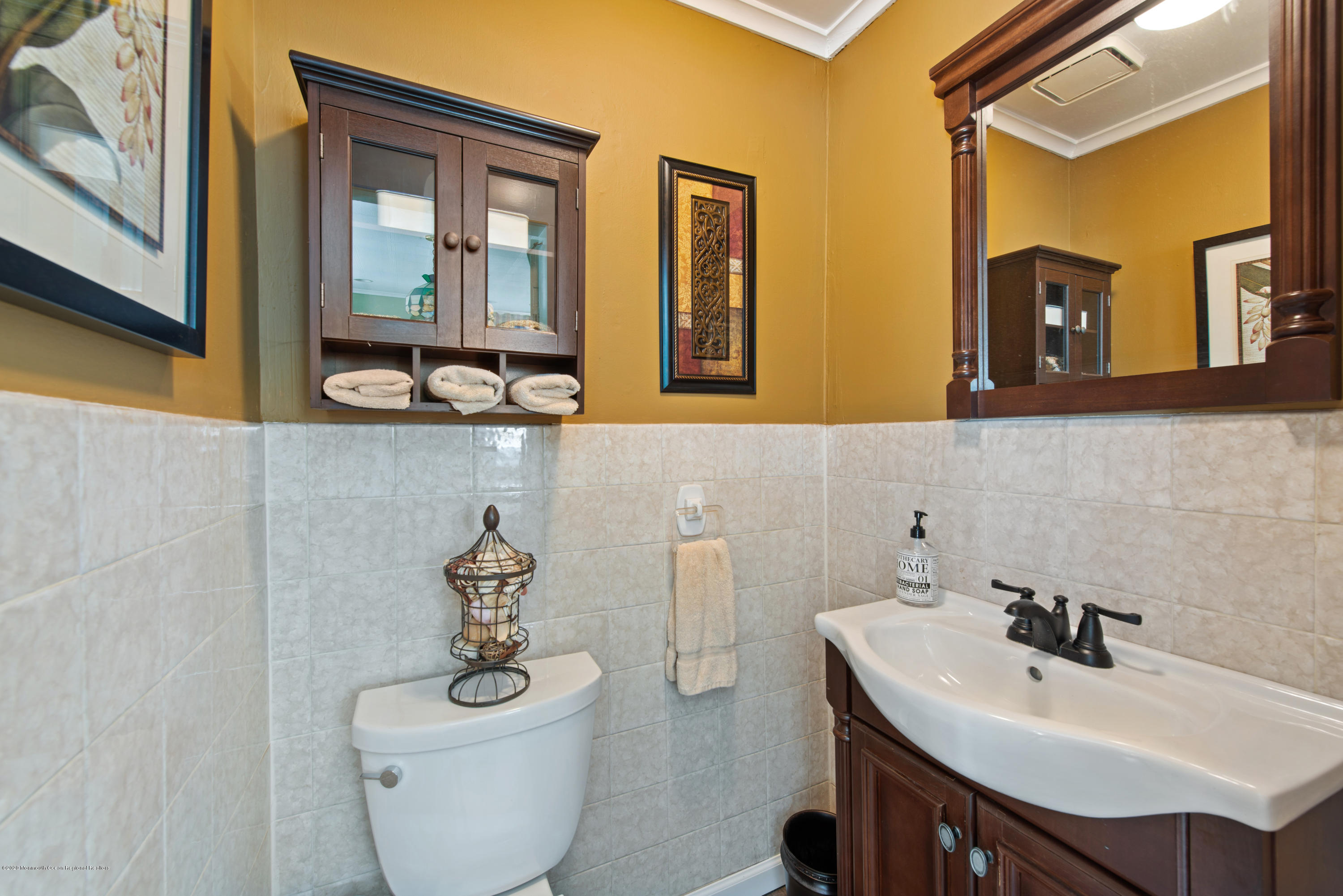 205 Main Street Keyport, NJ 07735 - Photo 34 of 42 a bathroom with a toilet a sink and mirror