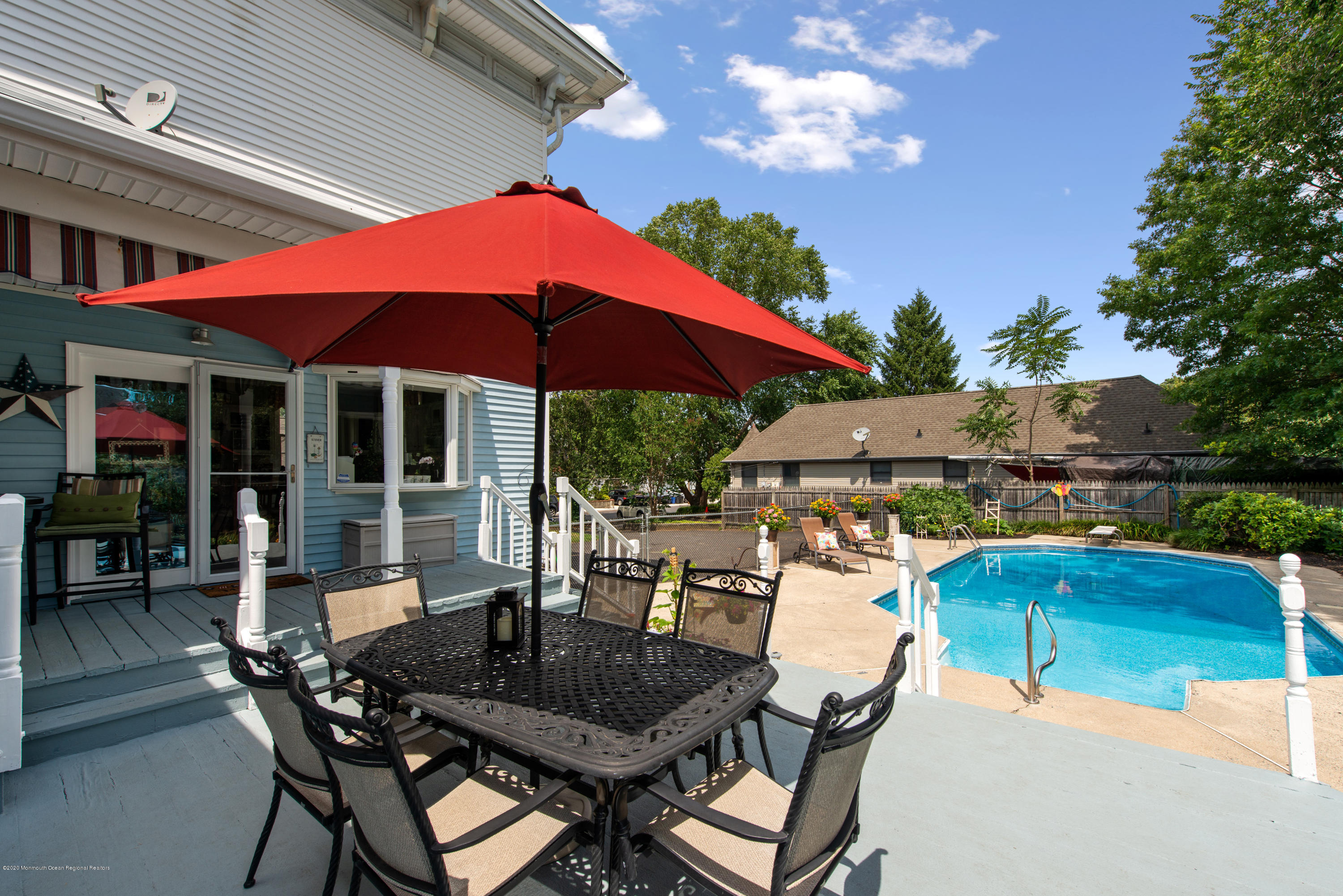 205 Main Street Keyport, NJ 07735 - Photo 38 of 42 a patio with a table and chairs under an umbrella