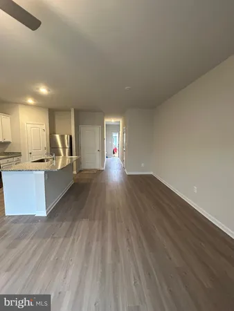 a view of kitchen and hall with wooden floor