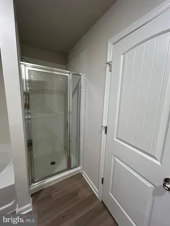 a bathroom with a glass door shower