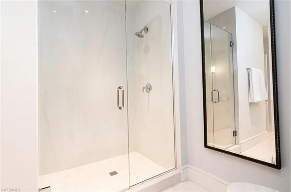 a bathroom with a glass shower door