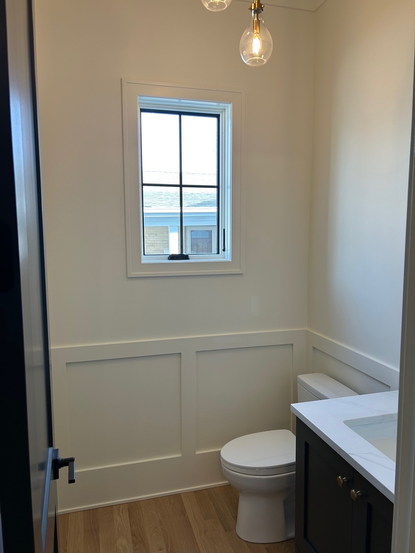 1413 Brophy Avenue Park Ridge, IL 60068 - Photo 13 of 34 a bathroom with a granite countertop toilet and a sink