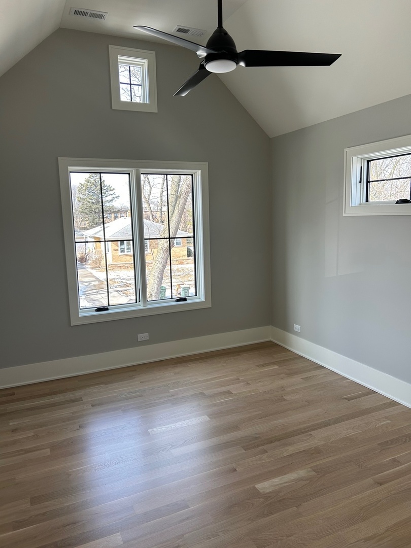 1413 Brophy Avenue Park Ridge, IL 60068 - Photo 29 of 34 a view of an empty room with wooden floor and a window
