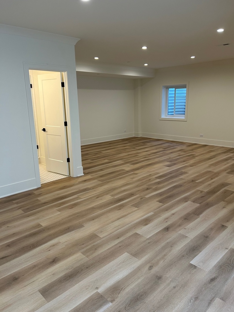 1413 Brophy Avenue Park Ridge, IL 60068 - Photo 31 of 34 an empty room with wooden floor and a window