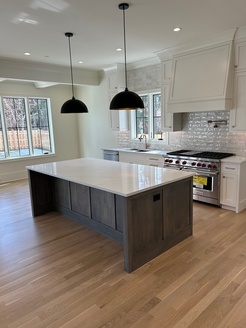 1413 Brophy Avenue Park Ridge, IL 60068 - Photo 5 of 34 a kitchen with stainless steel appliances granite countertop a stove a sink and a wooden floor