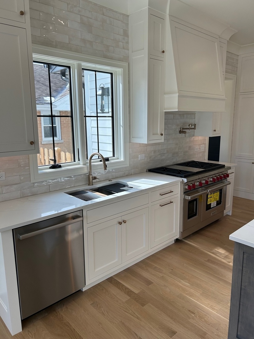 1413 Brophy Avenue Park Ridge, IL 60068 - Photo 8 of 34 a kitchen with stainless steel appliances a stove sink and window