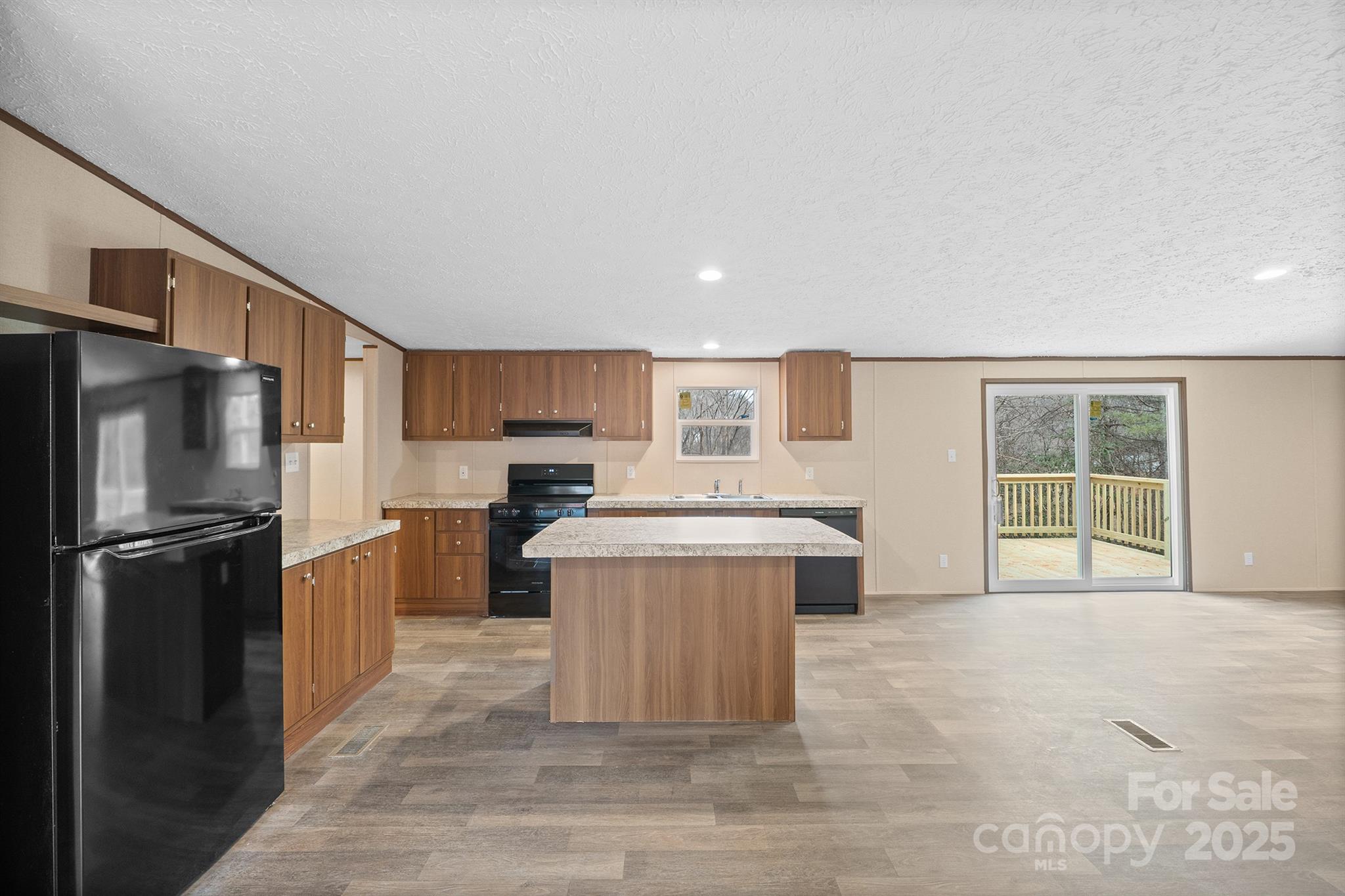 2490 Shadowbrook Drive Lenoir, NC 28645 - Photo 2 of 25 a living room with stainless steel appliances kitchen island granite countertop a refrigerator a stove a sink dishwasher with a dining table and chairs
