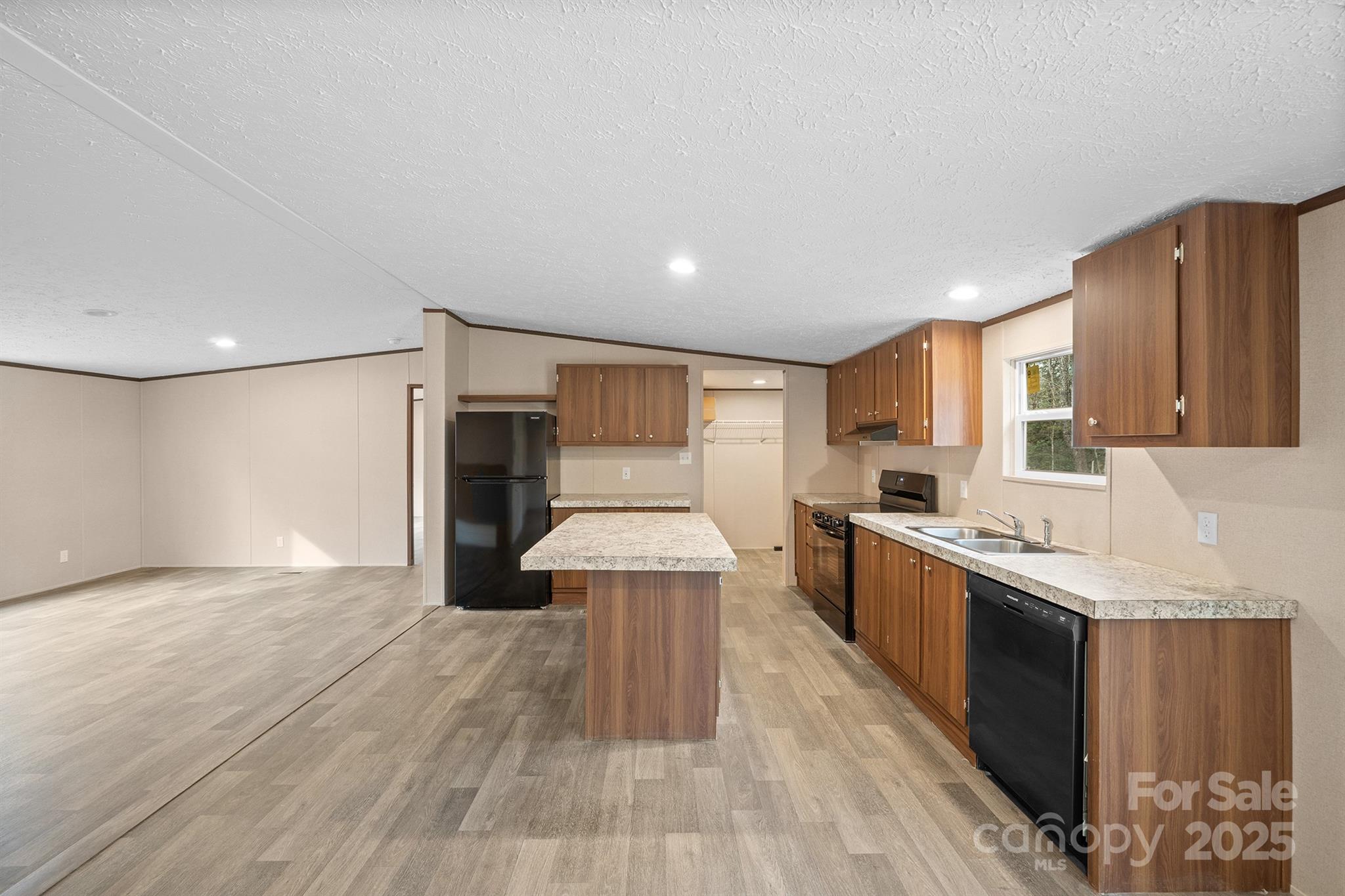 2490 Shadowbrook Drive Lenoir, NC 28645 - Photo 3 of 25 a large kitchen with stainless steel appliances granite countertop a large counter top a stove and a refrigerator