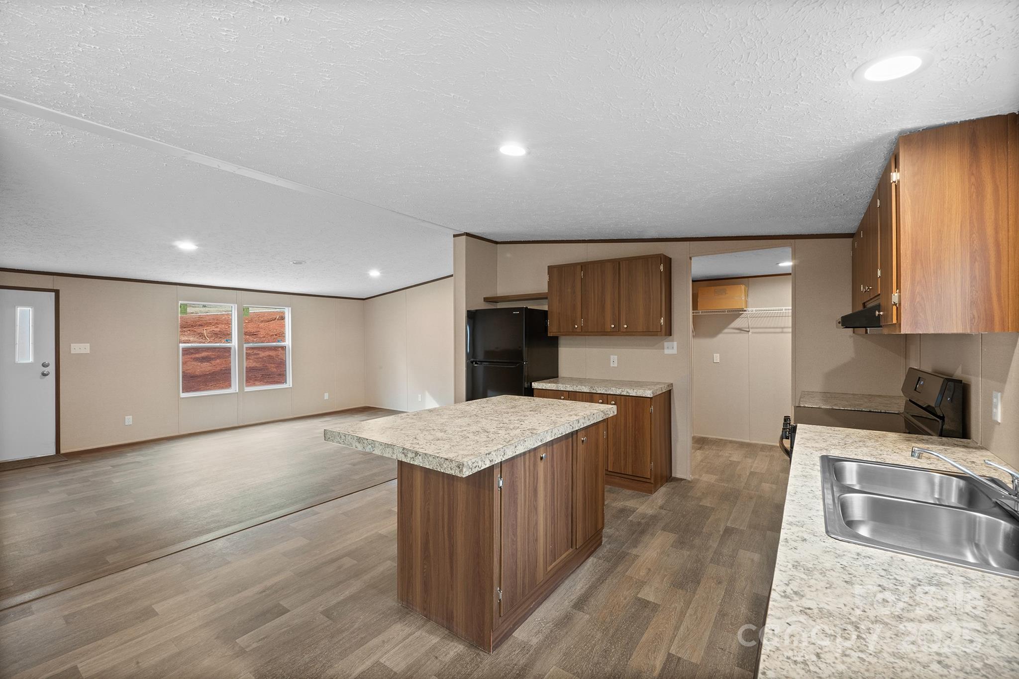 2490 Shadowbrook Drive Lenoir, NC 28645 - Photo 4 of 25 a large kitchen with stainless steel appliances granite countertop plenty wooden cabinets counter space and wooden floor